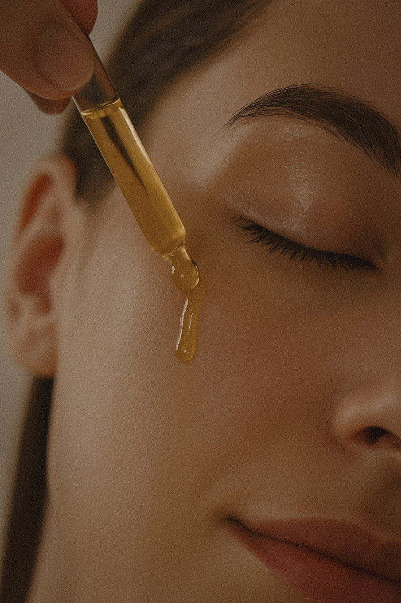 Organic face oil for dehydrated skin being applied to clean skin with fingertips